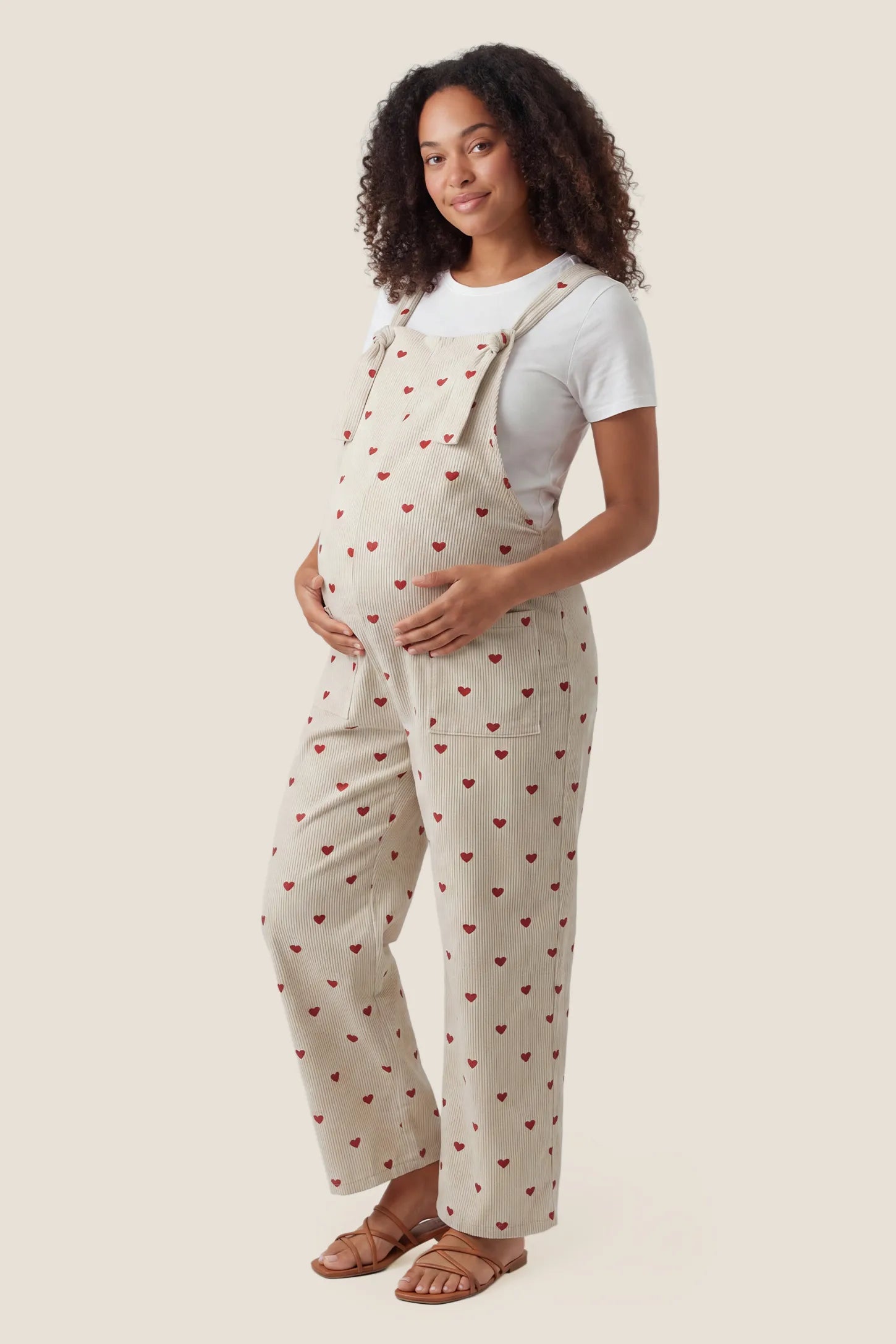 Pocketed Adjustable Maternity Overalls Side view of Pocketed Adjustable Maternity Overalls in Oat Cherry Heart.