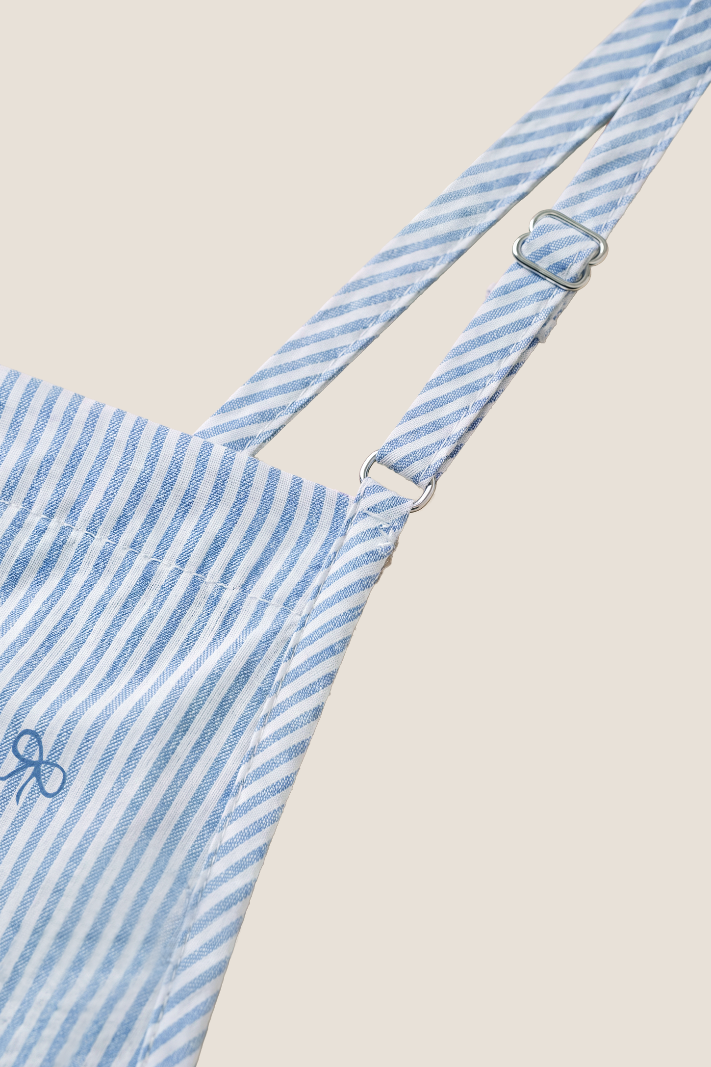 Side-Adjustable Maternity Jumpsuit Comfortable Pregnancy One-Piece Close-up of the striped fabric and embroidered bow print on the Side-Adjustable Maternity Jumpsuit Comfortable Pregnancy One-Piece in Baby Blue.