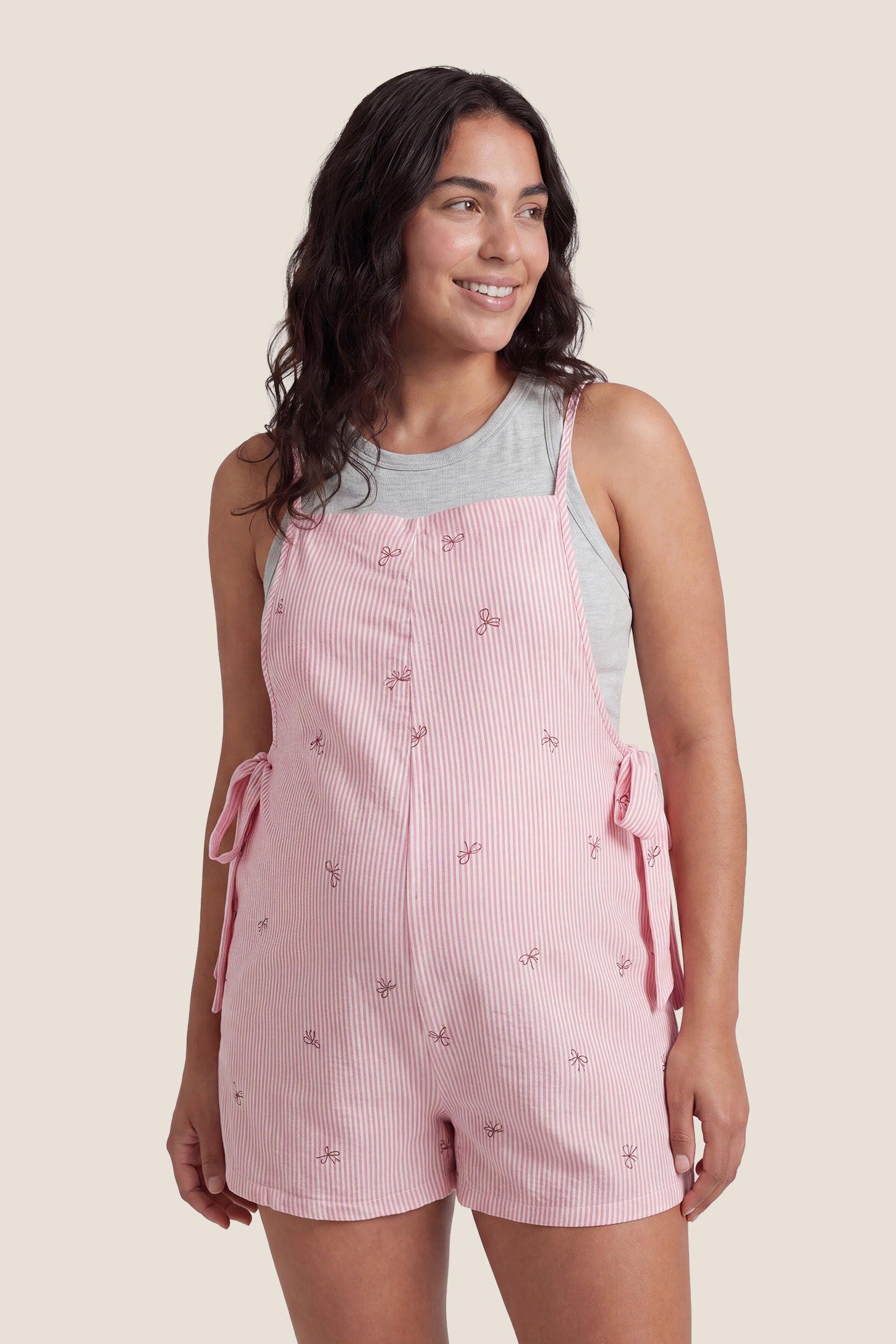 Side-Adjustable Maternity Jumpsuit Comfortable Pregnancy One-Piece Model wearing Side-Adjustable Maternity Jumpsuit Comfortable Pregnancy One-Piece in pink styled for postpartum comfort.