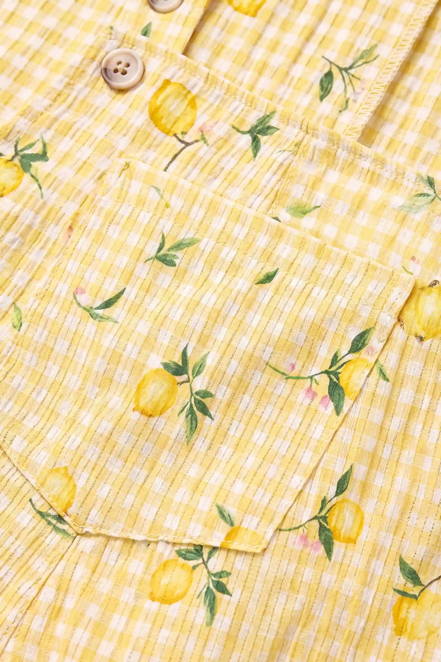 Sunny Day Adjustable Maternity Short Overalls Close-up of the lemon gingham fabric on the Sunny Day maternity short overalls