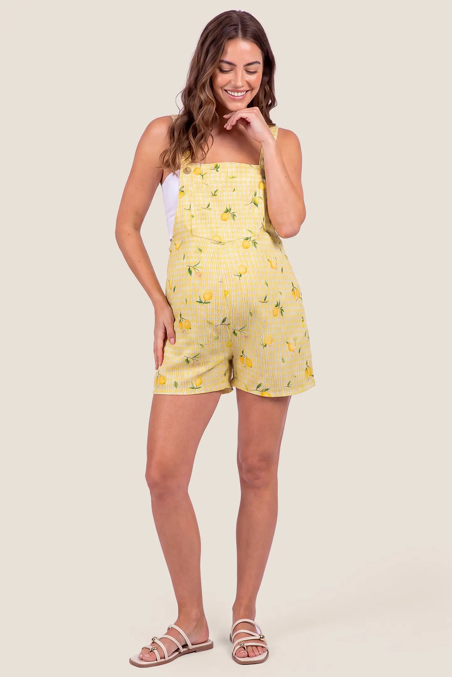Sunny Day Adjustable Maternity Short Overalls Full-length front view of a model wearing Sunny Day Adjustable Maternity Short Overalls in Lemon Gingham