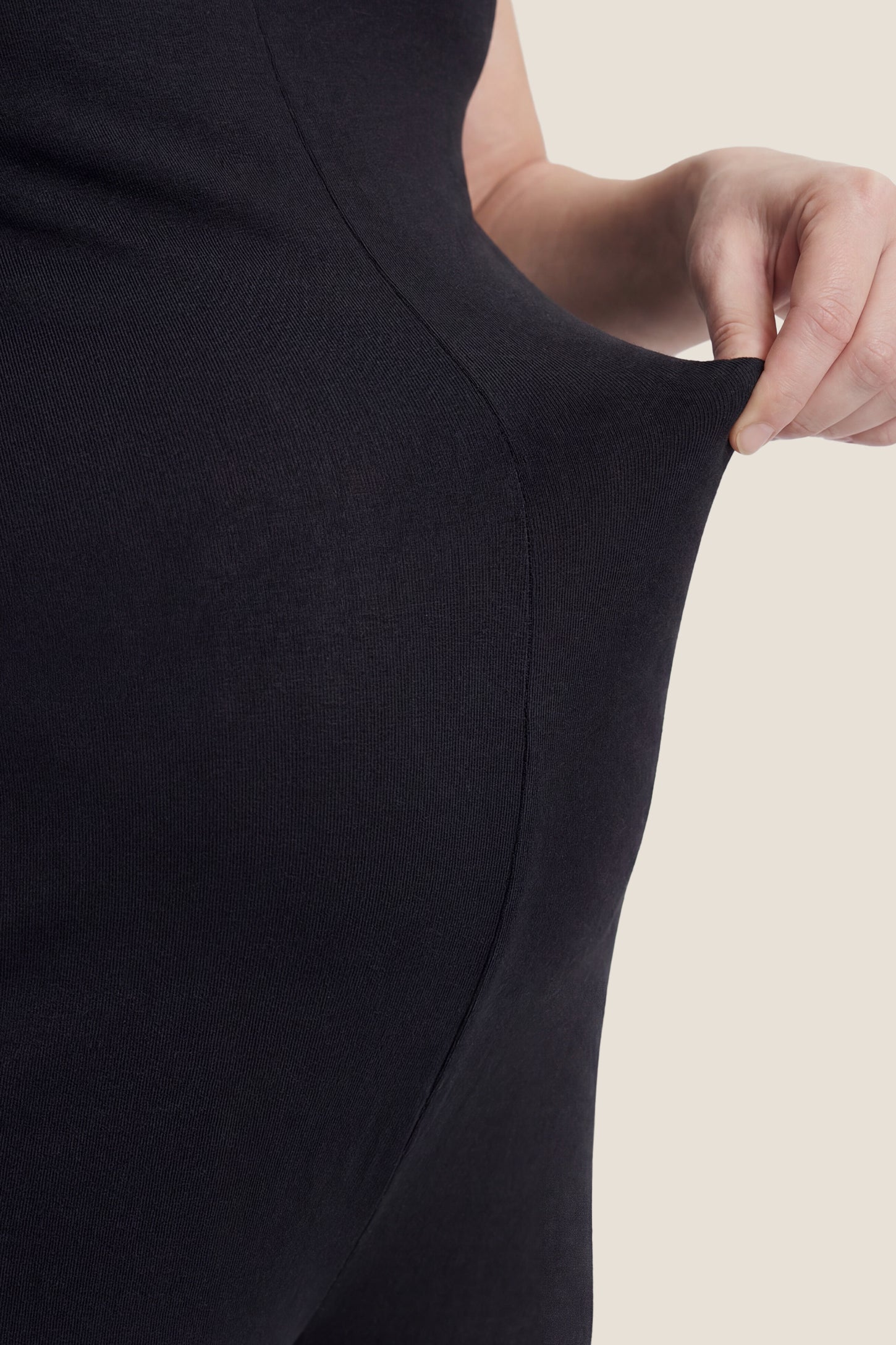 V-Neck Pocketed Maternity Jogger Jumpsuit Close-up of pocket detail on black V-neck pocketed maternity jogger jumpsuit